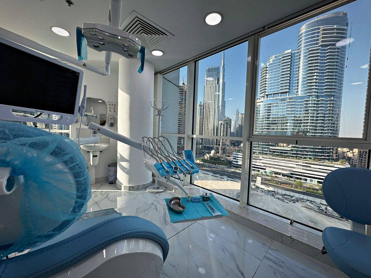 A treatment room at Murano Polyclinic with the Business Bay skyline through the window